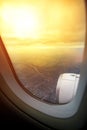 Through plane window flying over landscape