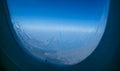 Plane window view with blue sky and clouds Royalty Free Stock Photo