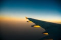 Plane window view of clouds and islands surrounded by sea and airplane wing. Traveling concept Royalty Free Stock Photo