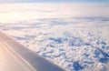 Plane window view of a wing and clouds in the sky Royalty Free Stock Photo