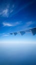Plane wing and beautiful blue sky from the plane window Royalty Free Stock Photo