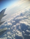 Plane wing, blue sky and clouds background, view from airplane window Royalty Free Stock Photo