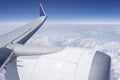 Plane wing in blue sky. Looking through window aircraft during flight in wing with a nice blue sky. Royalty Free Stock Photo