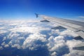 Plane wing flying above the clouds Royalty Free Stock Photo