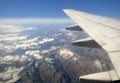 Plane wing over mountains