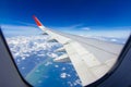 Plane wings over the sky and white clouds View from inside the plane Royalty Free Stock Photo