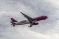 Plane Wizz Air in cloudy sky Royalty Free Stock Photo