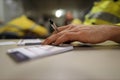 Planer holding black pen and placing his hand on top of personal safety risk assessment take five booklet on the table