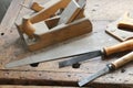 planes and chisels and a saw on the Workbench inside the craftsman joinery manufacturer