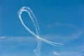 Planes in formation doing a loop with white smoke trail in blue Royalty Free Stock Photo