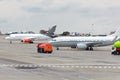 The planes are parked at the airport, close to filling cars. Royalty Free Stock Photo