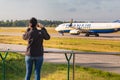 Planespotter taking photos with a cell phone