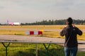 Planespotter taking photos with a cell phone