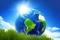 Planet Earth globe on green grass and sunlight over blue sky background. Concept of world environment day, save the Earth, Earth Royalty Free Stock Photo