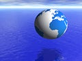 Planet earth globe over blue ocean and cloudy sky Royalty Free Stock Photo