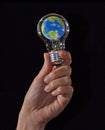 Planet earth inside a bulb lamp light on global new idea concept. Royalty Free Stock Photo