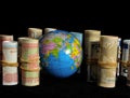 Planet Earth and Rolled Money Royalty Free Stock Photo