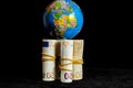 Planet Earth and Rolled Money Royalty Free Stock Photo