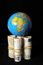 Planet Earth and Rolled Money Royalty Free Stock Photo