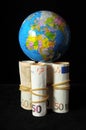 Planet Earth and Rolled Money Royalty Free Stock Photo