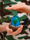 planet Earth in the shape of an egg in children& x27;s hands close-up. The concept of global problems of humanity, peace Royalty Free Stock Photo