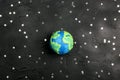 Planet Earth among the stars on a black background. Science, ecology, environmental protection