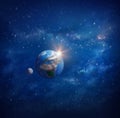 Planet Earth, sunrise and moon in outer space Royalty Free Stock Photo