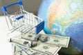 a planet earth in a supermarket shopping cart on blue background. copy space shopping trolley and toy ball in form of Royalty Free Stock Photo