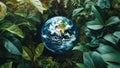 Planet earth surrounded by green leaves.