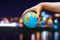Globe planet Earth in the hands of man against the night city. Concept of ecology and media. Earth night background Royalty Free Stock Photo