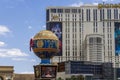 Planet Hollywood in the city skyline with video billboards, blue sky and clouds at the Bellagio Hotel in Las Vegas Nevada