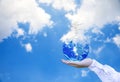 Planet and tree in human hands over blue sky with white clouds, Save the earth concept, Royalty Free Stock Photo