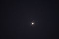 The planet Venus in the starry night sky in conjunction with the Pleiades Constellation