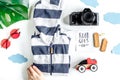 Planing trip with child with clothes and camera white background top view Royalty Free Stock Photo