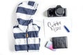 Planing trip with child with clothes and camera white background top view Royalty Free Stock Photo