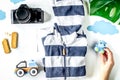 Planing trip with child with clothes and camera white background top view Royalty Free Stock Photo
