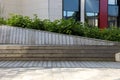 Plank bench. Geometric wooden bench. Street furniture to have a rest in the town