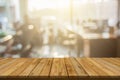 Plank wooden table top and blurred abstract background from interior building banner backdrop with desk blur, counter work people Royalty Free Stock Photo