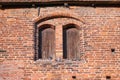 Planked double windows with arches and two doves in the red brick wall of the historic church of Rehna, gothic brick Royalty Free Stock Photo