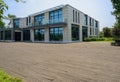 Planked ground before two-storied building in sunny summer