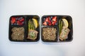 Planned meal containers with salmon, asparagus, quinoa and fruit for a healthy lunch. Royalty Free Stock Photo