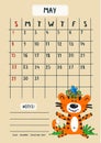 Planner calendar for May 2022. A cute tiger cub sits on the grass with birds