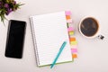 Planner on the grey working table with phone and coffee. Blank white paper on working desk Royalty Free Stock Photo