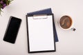 Planner on the grey working table with phone and coffee. Blank white paper on working desk Royalty Free Stock Photo
