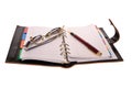 Planner, pen and eyeglasses Royalty Free Stock Photo