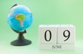 Planner wooden cube with numbers, 9 day of the month of June, summer