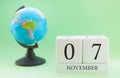 Planner wooden cube with numbers, 7 day of the month of November, autumn