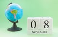 Planner wooden cube with numbers, 8 day of the month of November, autumn