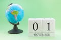 Planner wooden cube with numbers, 1 day of the month of November, autumn