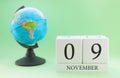 Planner wooden cube with numbers, 9 day of the month of November, autumn